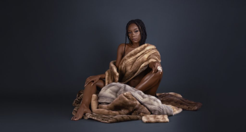 Sensual Young Black Lady Sitting in Fur