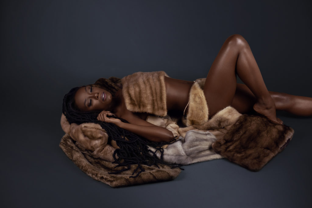 Sensual Young Black Lady Laying on Fur