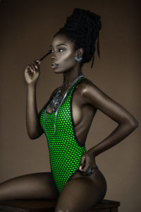 Serene Young Black Lady In Green Bathing Suit